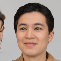 Joyful asian young-adult male with short  brown hair and brown eyes