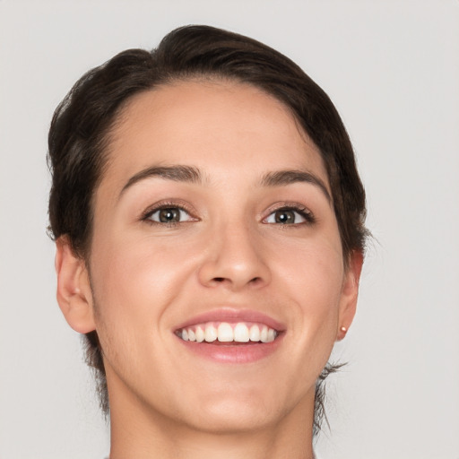 Joyful white young-adult female with short  brown hair and brown eyes