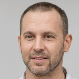 Joyful white adult male with short  brown hair and brown eyes