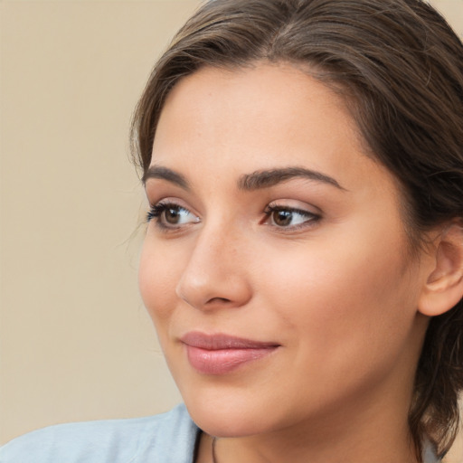 Joyful white young-adult female with medium  brown hair and brown eyes