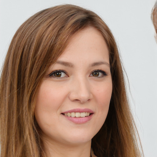 Joyful white young-adult female with long  brown hair and brown eyes