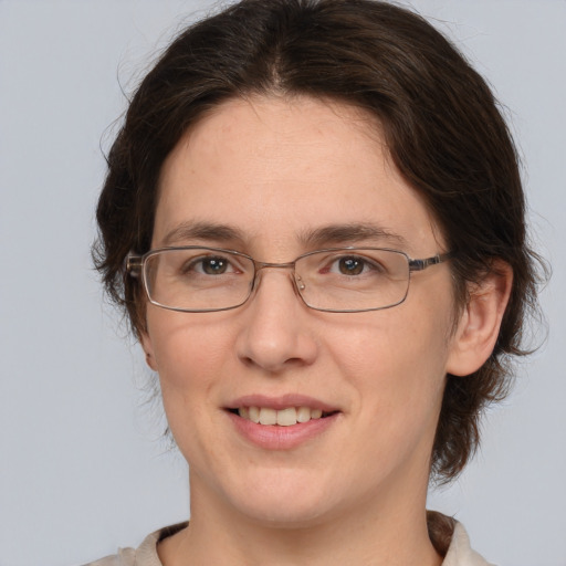 Joyful white adult female with medium  brown hair and brown eyes