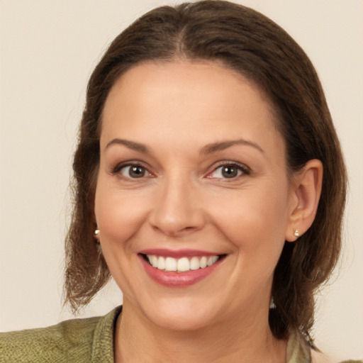 Joyful white young-adult female with medium  brown hair and brown eyes