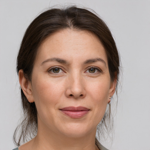 Joyful white adult female with medium  brown hair and brown eyes