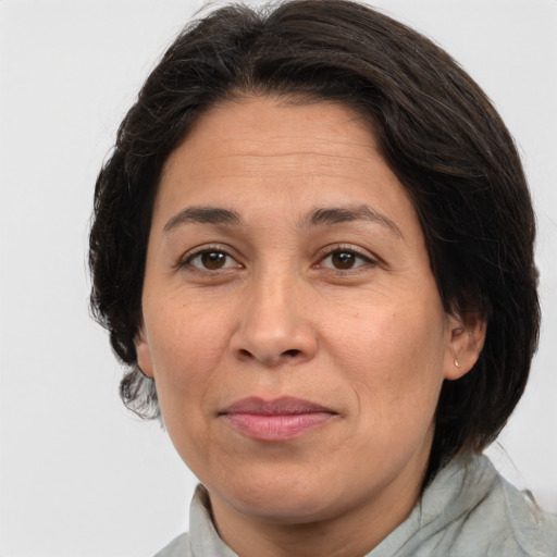 Joyful white adult female with medium  brown hair and brown eyes