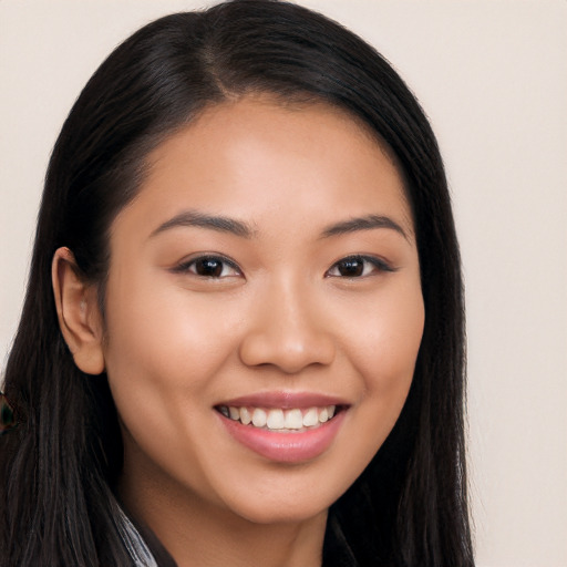 Joyful asian young-adult female with long  black hair and brown eyes