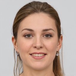 Joyful white young-adult female with long  brown hair and grey eyes