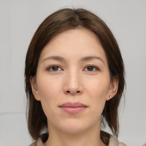 Joyful white young-adult female with medium  brown hair and brown eyes