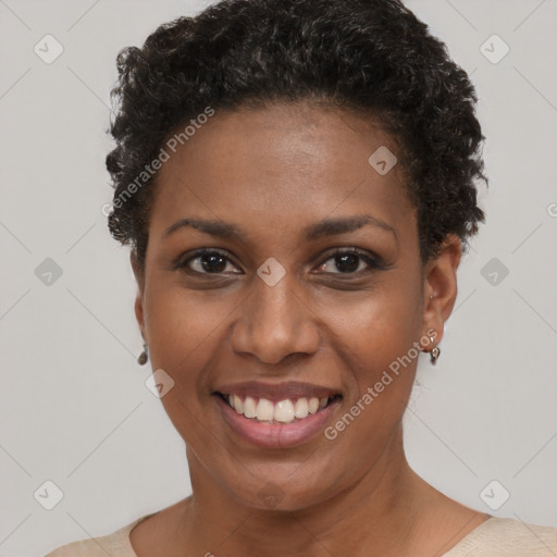 Joyful black young-adult female with short  black hair and brown eyes