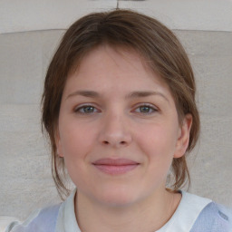 Joyful white child female with medium  brown hair and blue eyes