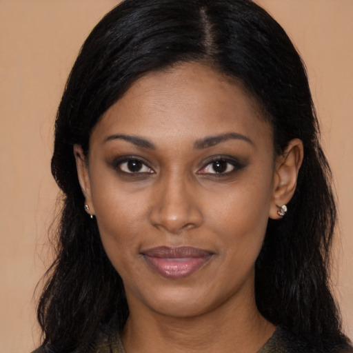 Joyful black young-adult female with long  black hair and brown eyes