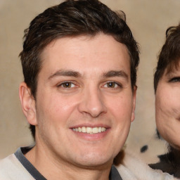 Joyful white adult male with short  brown hair and brown eyes