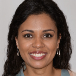 Joyful black young-adult female with medium  brown hair and brown eyes