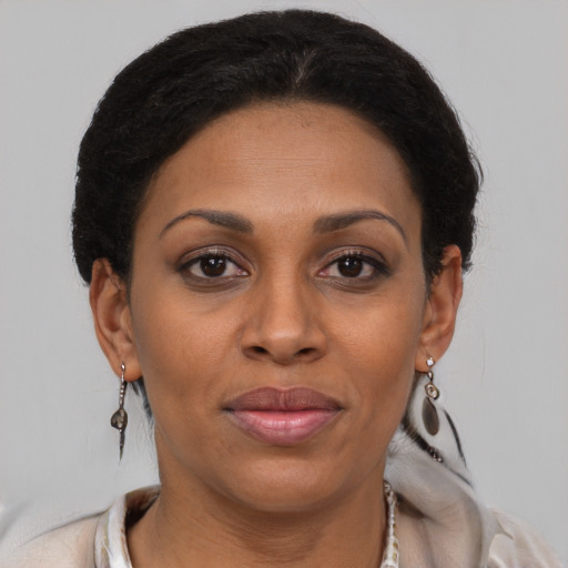 Joyful latino adult female with short  brown hair and brown eyes
