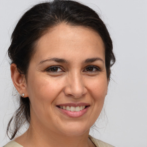 Joyful white adult female with medium  brown hair and brown eyes