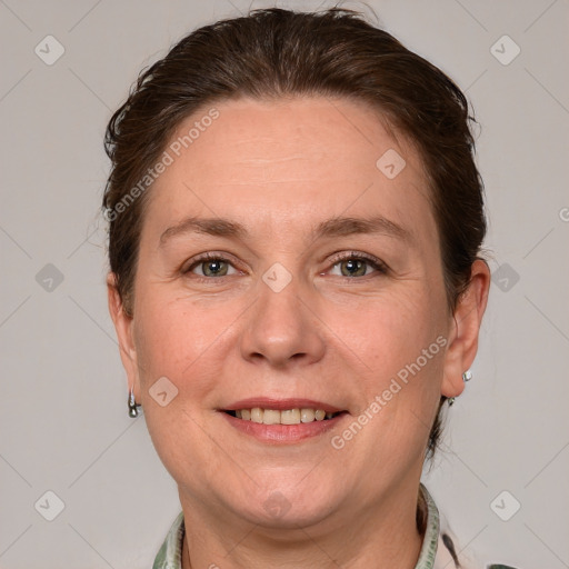 Joyful white adult female with medium  brown hair and grey eyes