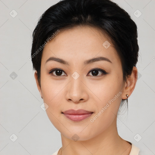 Joyful asian young-adult female with short  black hair and brown eyes