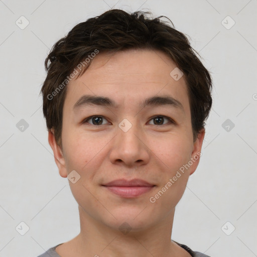 Joyful asian young-adult male with short  brown hair and brown eyes