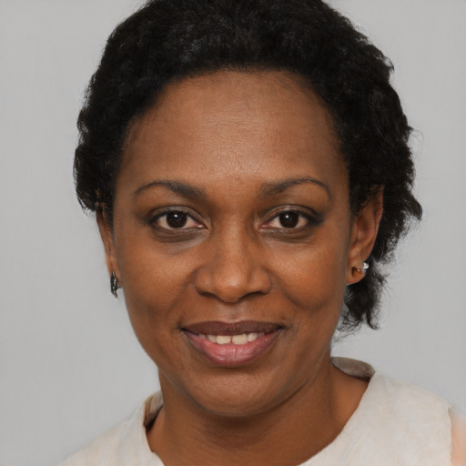 Joyful black adult female with short  black hair and brown eyes