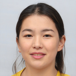 Joyful asian young-adult female with medium  brown hair and brown eyes