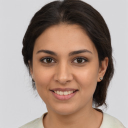 Joyful latino young-adult female with medium  brown hair and brown eyes