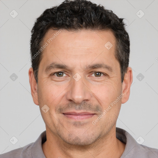 Joyful white adult male with short  black hair and brown eyes