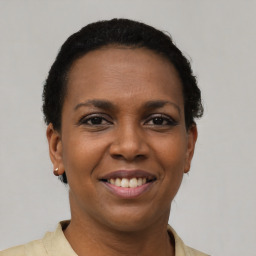 Joyful latino young-adult female with short  brown hair and brown eyes