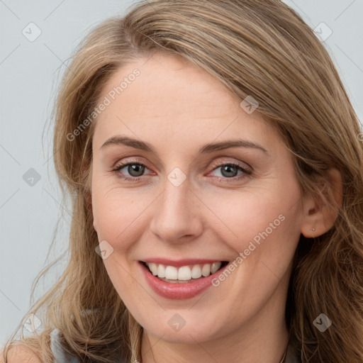 Joyful white young-adult female with long  brown hair and blue eyes