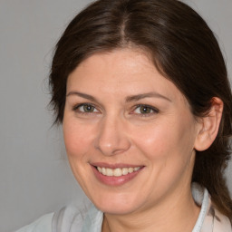 Joyful white adult female with medium  brown hair and brown eyes