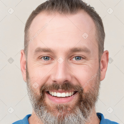 Joyful white adult male with short  brown hair and grey eyes