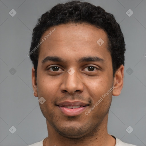 Joyful black young-adult male with short  black hair and brown eyes