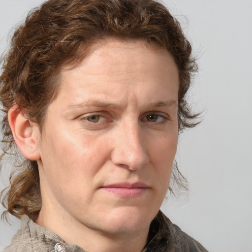 Joyful white adult male with medium  brown hair and grey eyes