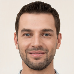 Joyful white young-adult male with short  brown hair and brown eyes