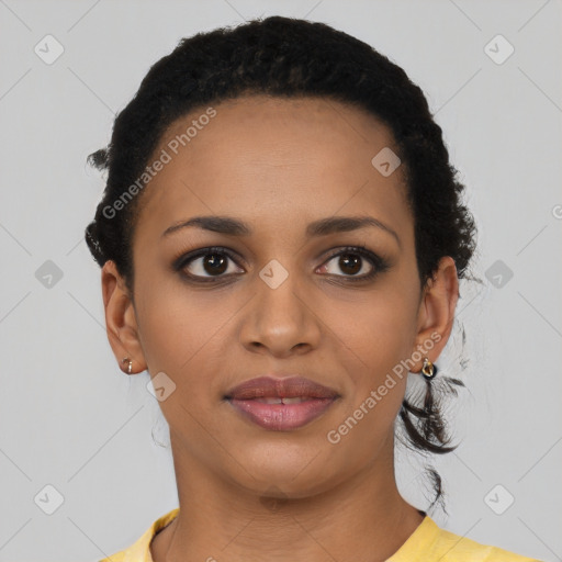 Joyful black young-adult female with short  black hair and brown eyes