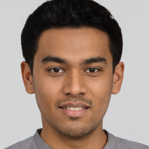 Joyful latino young-adult male with short  black hair and brown eyes