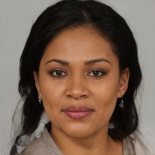 Joyful black young-adult female with medium  brown hair and brown eyes