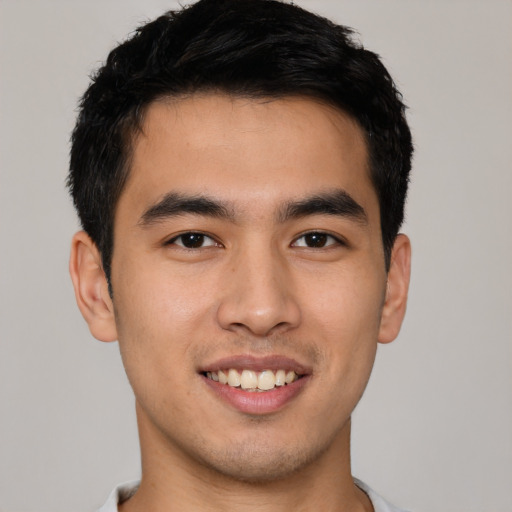 Joyful asian young-adult male with short  black hair and brown eyes