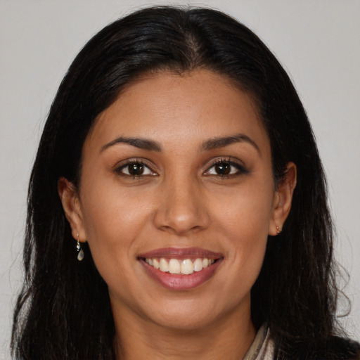 Joyful latino young-adult female with long  brown hair and brown eyes
