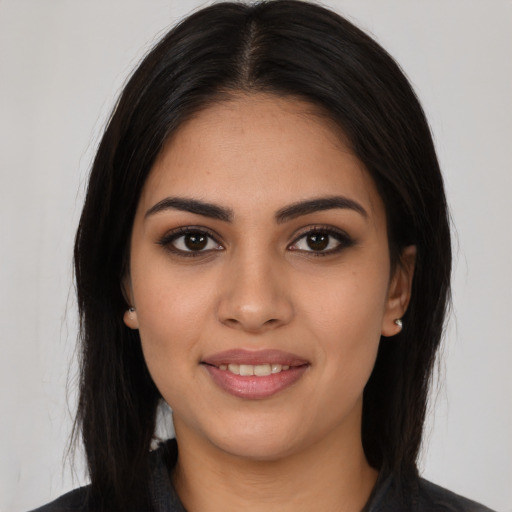 Joyful latino young-adult female with long  brown hair and brown eyes