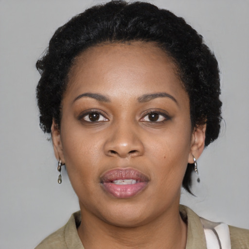 Joyful black young-adult female with short  brown hair and brown eyes
