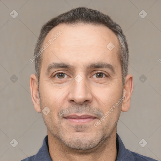 Joyful white adult male with short  black hair and brown eyes