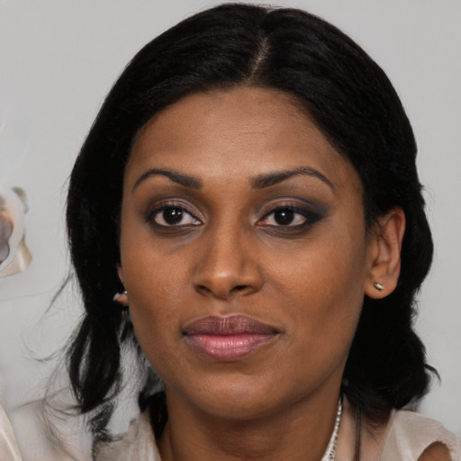 Joyful black young-adult female with medium  black hair and brown eyes