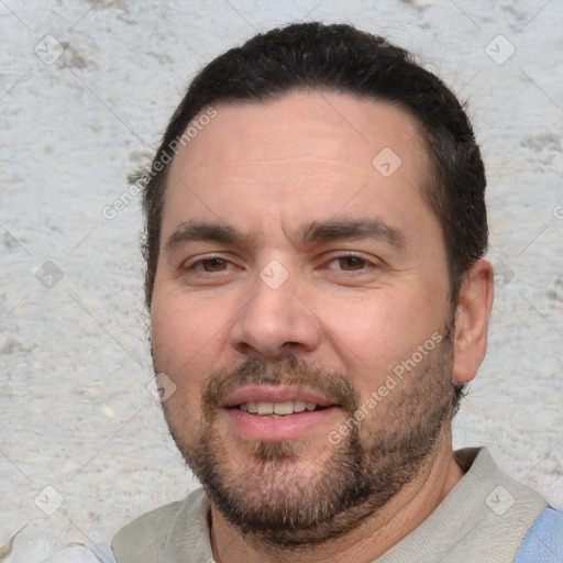 Joyful white adult male with short  black hair and brown eyes