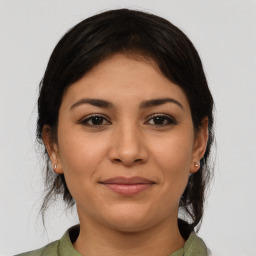 Joyful latino young-adult female with medium  brown hair and brown eyes