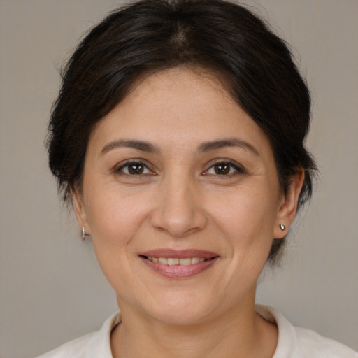 Joyful white adult female with medium  brown hair and brown eyes