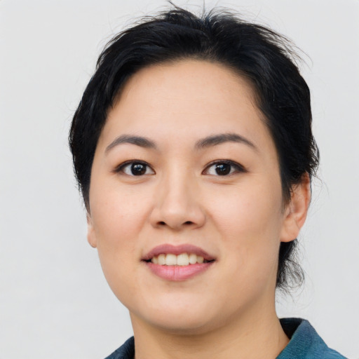 Joyful asian young-adult female with medium  black hair and brown eyes