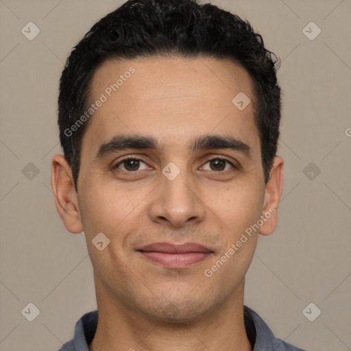 Joyful white young-adult male with short  black hair and brown eyes