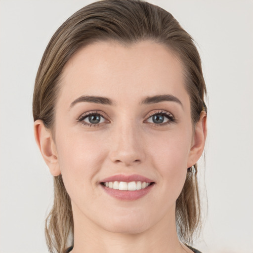 Joyful white young-adult female with medium  brown hair and grey eyes