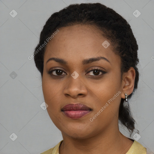 Joyful black young-adult female with long  brown hair and brown eyes