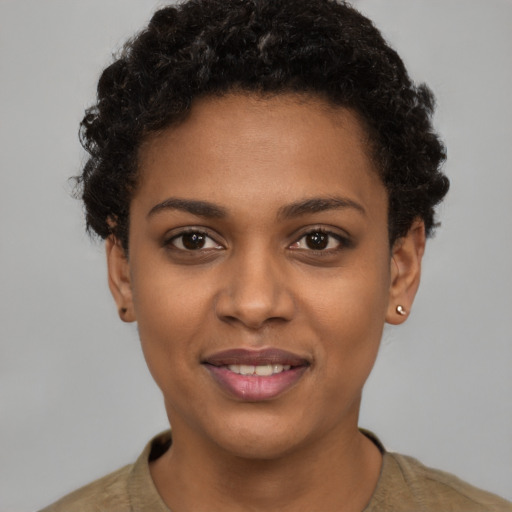 Joyful black young-adult female with short  brown hair and brown eyes